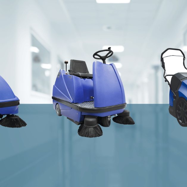 Three Stolzenberg Suresweep Industrial Vacuum Floor Sweepers side by side in front of a hospital setting background with a hint of blue