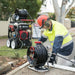 Jetwave Scorpion G2FI 275-20 Cold Water Pressure Cleaner worker in with hose reel to clean a roadside drain.