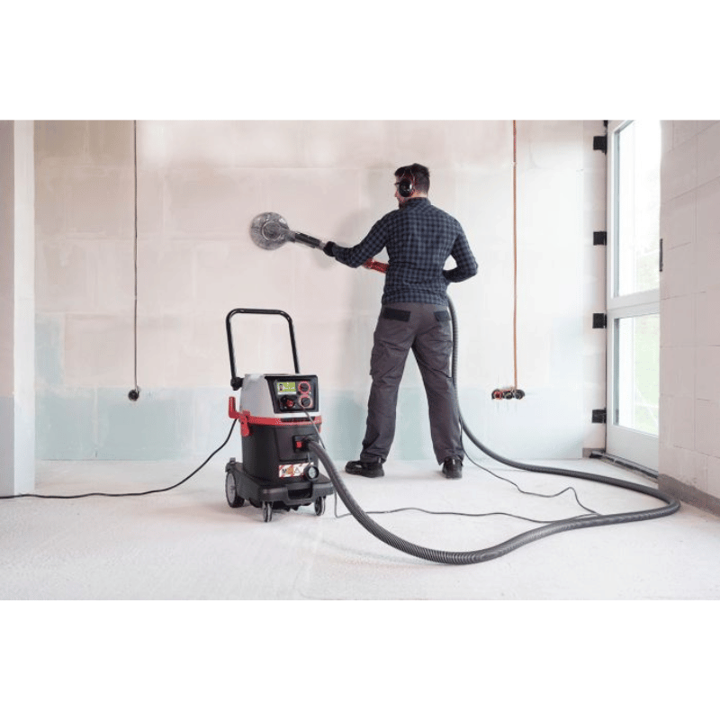 Person using a SPRiNTUS Craftix 35M M Class Commercial Vacuum Cleaner in an indoor setting