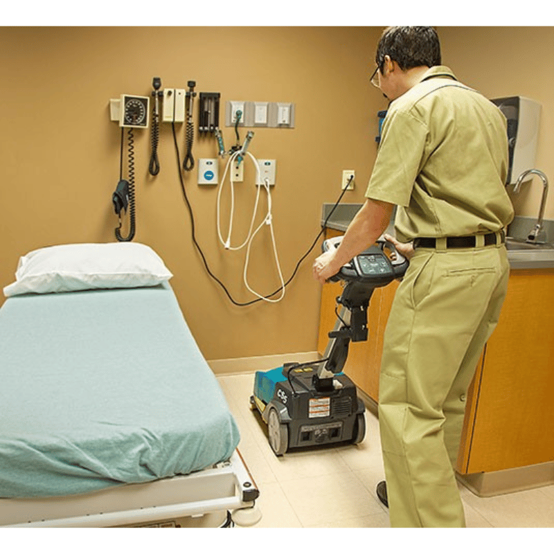 Person using a Tennant CS5 Micro Floor Scrubber in a medical setting