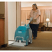 Tennant E5 Compact Walk Behind Carpet Extractor being used by a person in a motel room on carpet floor