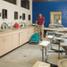 Person using a floor cleaning machine in a classroom setting