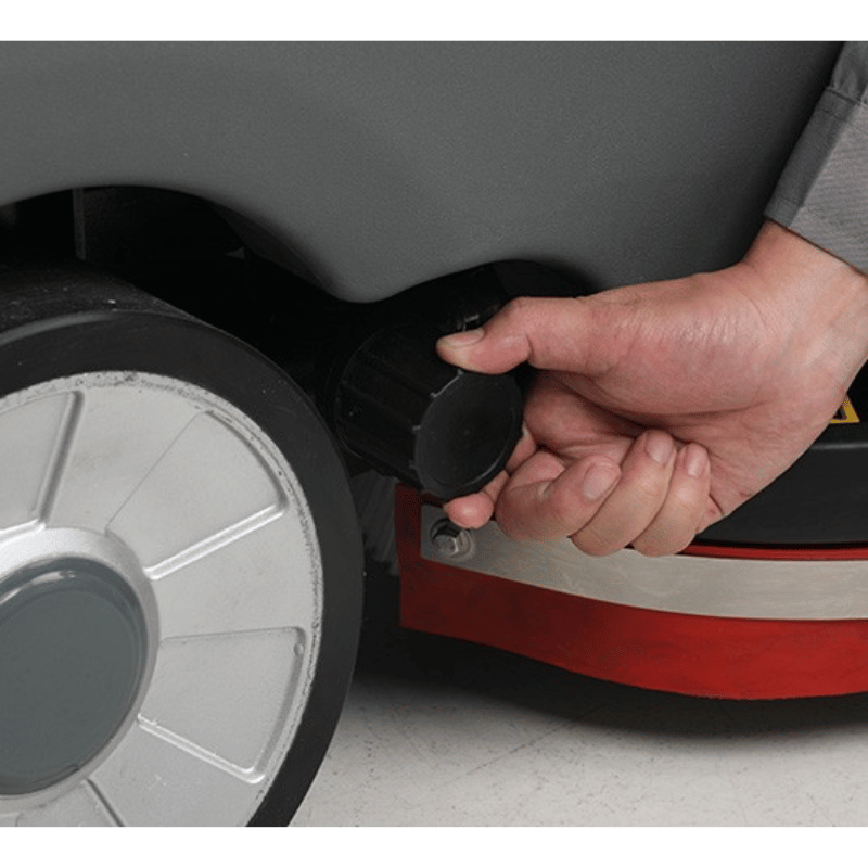 Tennant T560 Micro Ride On Floor Scrubber close up view of wheel and drain hose