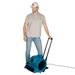 XPOWER X-800HC Heavy Duty Air Mover with wheels being used by a man on a white background