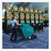 Tennant 1610 ReadySpace Dual Technology Extractor being used by a lady at a casino on blue coloured carpet floor. 