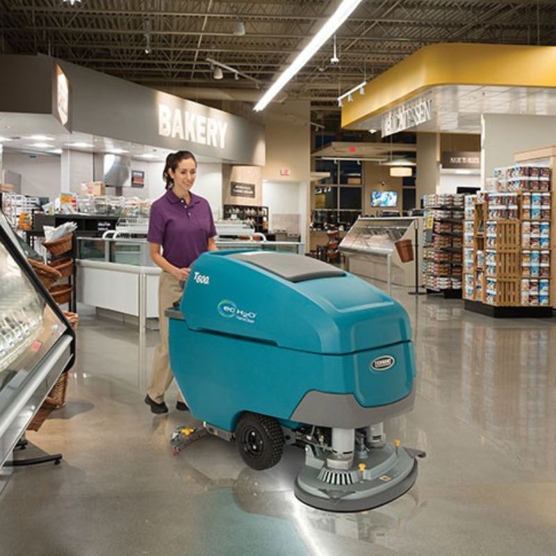 Tennant T600 Walk-Behind Floor Scrubber  as women use it in the grocery store