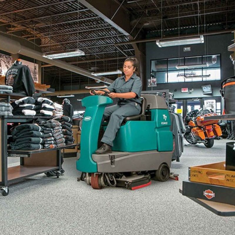 Tennant T7 Ride-On Floor Scrubber cleaning warehouse floors